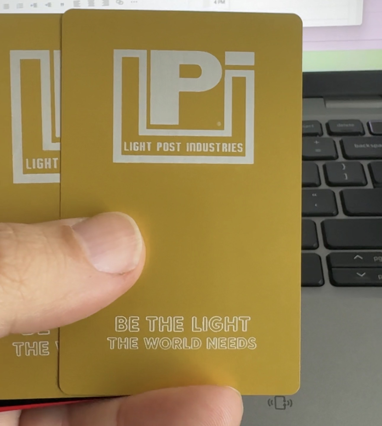 Light Post Industries Gold anodized business card — front
