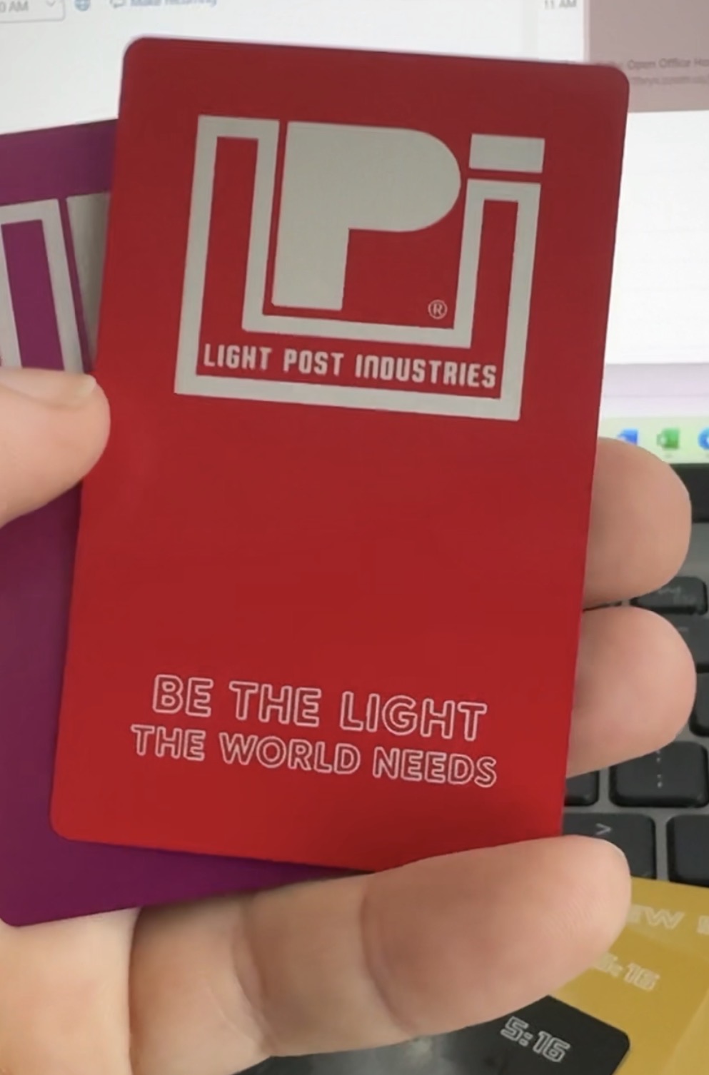 Light Post Industries Red anodized business card — front